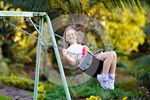 Child swinging on playground. Kids swing