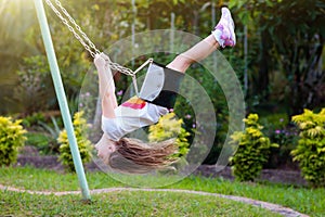 Child swinging on playground. Kids swing