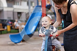 Child swinging on spring toy horse