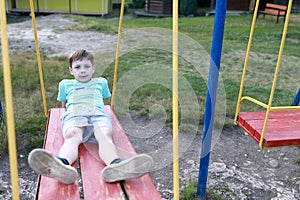 Child swinging on swing in park