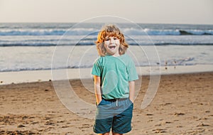 Child in t-shirt walking on the summer beach. Amazed surprised kids emotions.