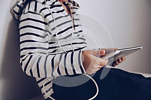 Child with tablet sitting on the floor