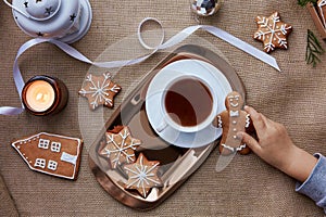 Child takes homemade Christmas gingerbread cookies and cocoa. Aesthetic seasonal Christmas decorations with hot drink