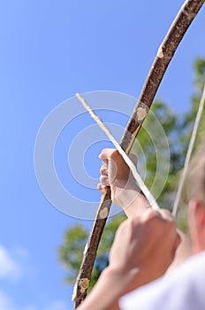 Child taking aim with an arrow