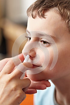 Child taking a dose of nasal spray
