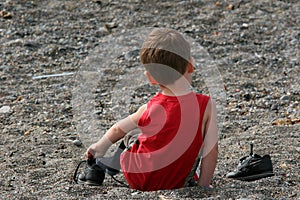 Child Taking His Trainers Off