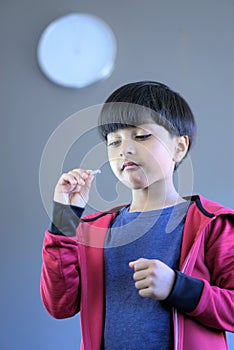 Child taking medicine or vitamins on time