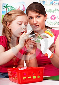 Child with teacher glue in play room.