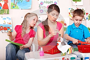 Child with teacher in play room.