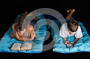 Child and teen boy reading book and ebook