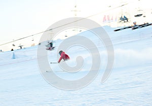 Child teenager boy skiing fast in mountains