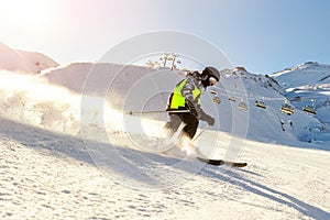 Child teenager boy skiing fast in mountains. School boy having fun running downhill slope at alpine resort during winter