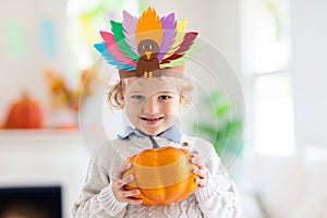 Child on Thanksgiving. Kid with autumn turkey hat