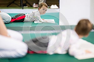 Child on Therapy Mat During SessionYoung boy on a therapy mat during a physiotherapy session, engaging in a supervised
