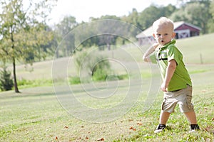 Child Throwing a Ball Outside