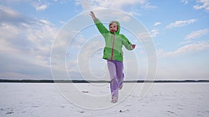 A child throws dust on a dry salt lake.