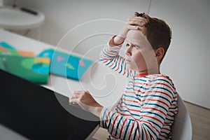 Child tired and bored of doing homework, kid stressed from learning