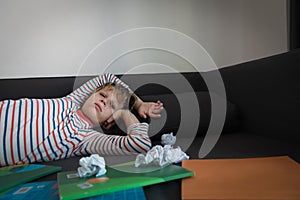 Child tired and bored of learning and doing homework