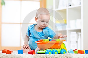 Child toddler playing wooden toys at home