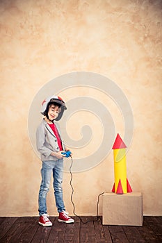 Child with toy paper rocket