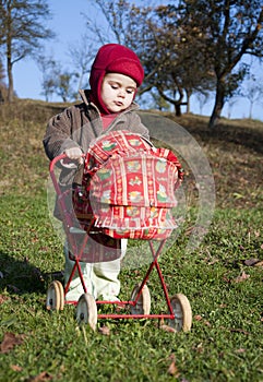 Child with a toy pram