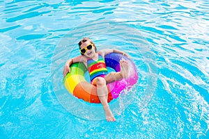 Child with toy ring in swimming pool