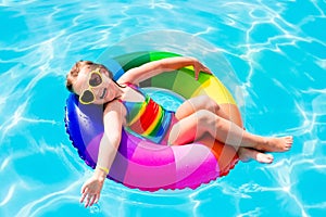 Child with toy ring in swimming pool