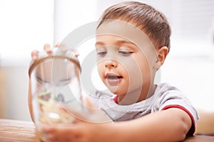 Child, toys and jar for playing for development, growth curiosity and young boy. Kid, animals and game or learning