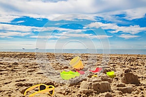 child toys in the sand on the beach