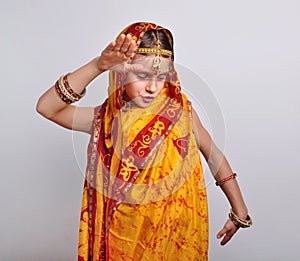 Child in traditional Indian clothing and jeweleries dancing