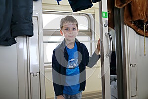 Child in train compartment doorway