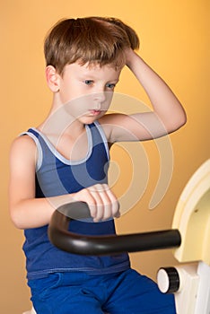 The child is trained on a stationary bike . Healthy lifestyle.