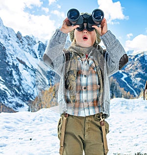 Child travellers looking into the distance through binoculars