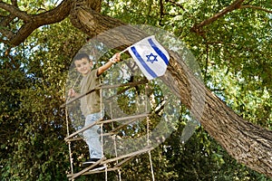 Child on Tree with Israeli Flag.