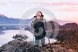 Child with trekking poles on Bled Lake, Slovenia, Europe