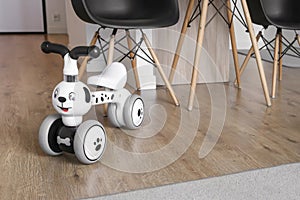 Child tricycle balance bike in the living room. Modern interior. Children and renovation