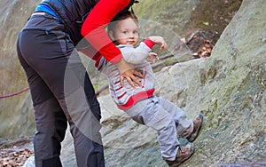 A child tries to climb on the rock.