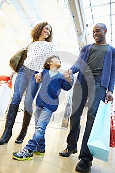 Child On Trip To Shopping Mall With Parents