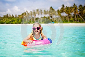 Child on tropical beach. Sea vacation with kids