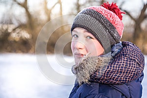 Child turn around and looking at the camera in winter park during winter holidays