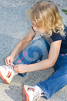 Child tying shoe.