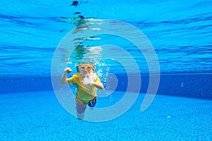 Child underwater in swimming pool. Kids swim