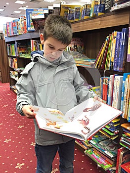 Child with unfold book in a bookstore