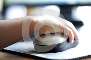 Child using computer mouse