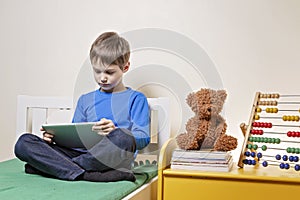 Child using digital tablet computer at home