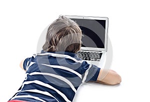 Child using laptop computer on the floor