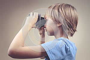 Child using new Virtual Reality, VR cardboard glasses