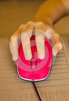 A Child using a pink mouse