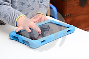 Child using a tablet touch screen device