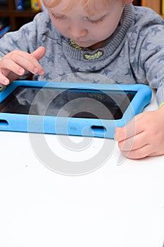 Child using a tablet touch screen device